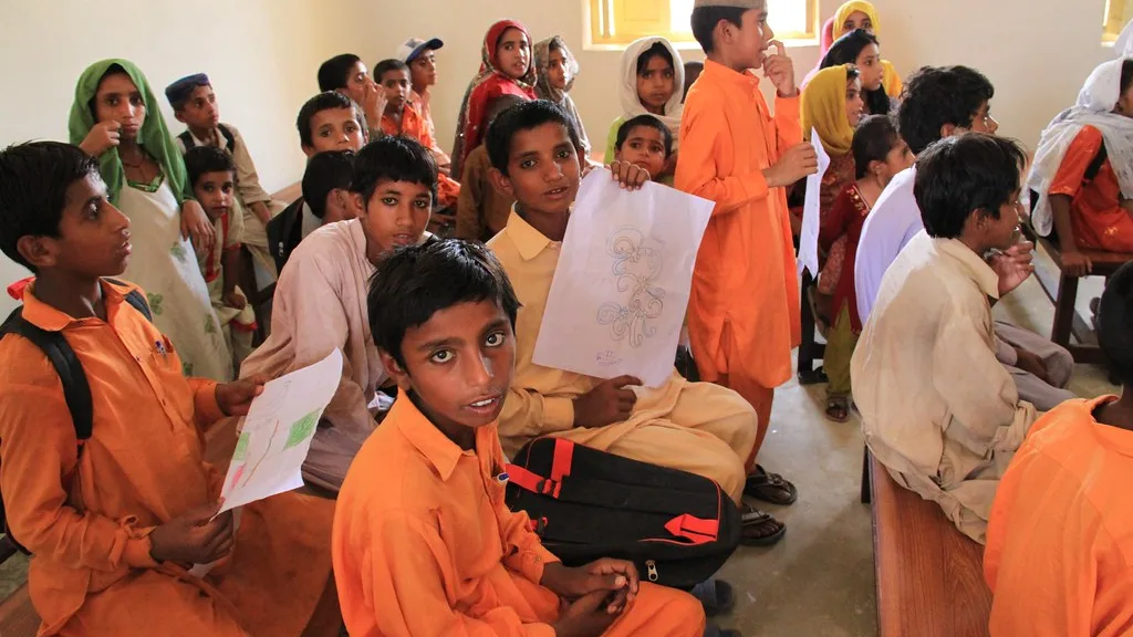 Children in school uniforms in a classroom in Sindh, Pakistan, the kind of school enrolment Taleemi Wazaif supports